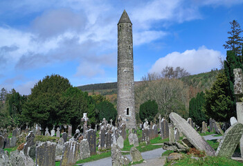 Stone round tower and cemetery from a medieval monastery