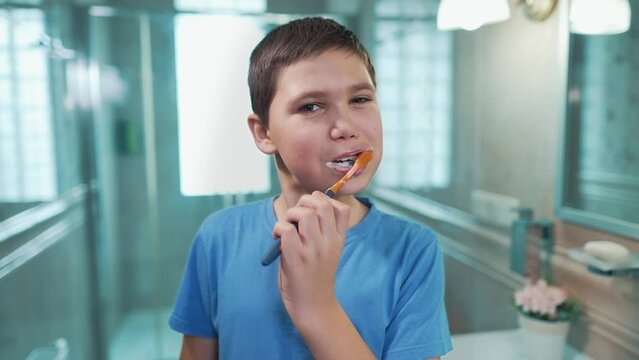 Boy brushing teeth in the bathroom