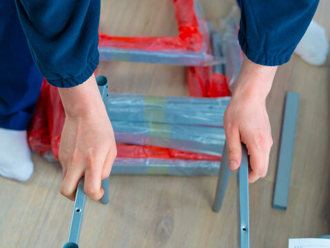 handyman making furniture assembly using tools for repair.