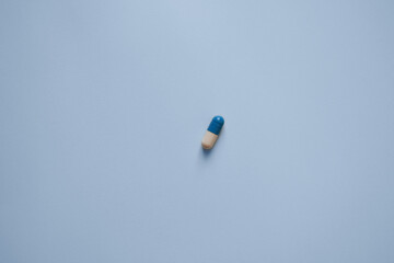 pill capsule on a blue background, medication, medical workers day, medical care, banner for the hospital