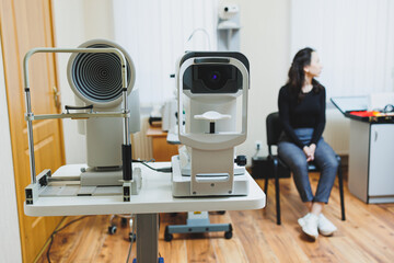 Examination of vision on modern ophthalmological equipment. Eye examination of a woman at an...