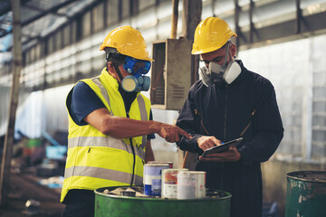 Chemical leak and safety first concept. Group of chemical specialist wear safety uniform, gas mask inspecting chemical leak in industry factory. Two scientists checking quality of liquid in plant - obrazy, fototapety, plakaty