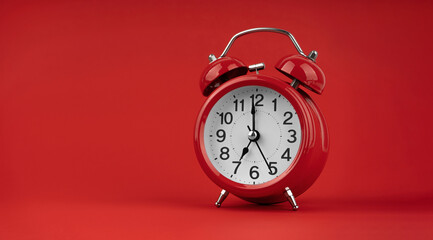 Red alarm clock on a red background.