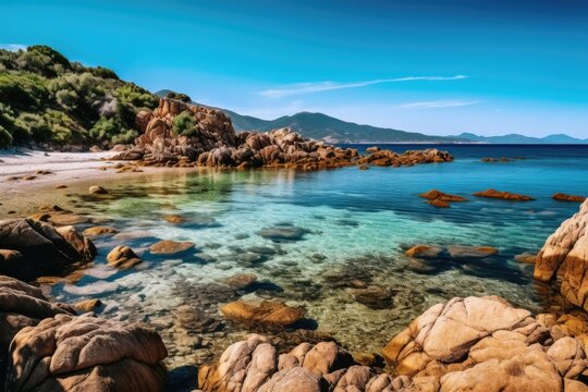 a serene beach with crystal clear blue water and rocky shoreline