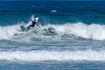 Surfer riding waves in Furadouro Beach