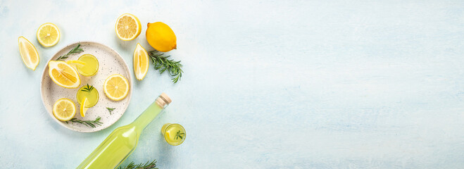 limoncello. traditional strong alcoholic drink and lemons. Long banner format. top view