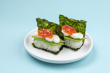 Portion of japanese hand rolls with caviar and avocado