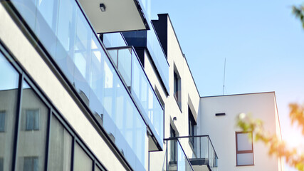 Apartment building with bright facades. Modern minimalist architecture with lots of square glass...