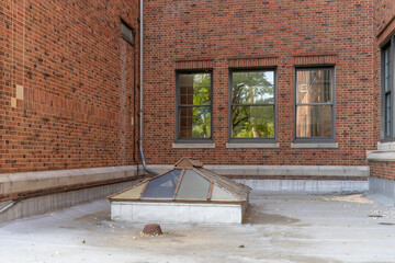 Old, vintage metal framed double pitched skylight on a flat commercial, industrial, or school...
