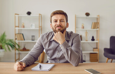 Head shot portrait of businessman looking at webcam having video call or conversation. Confident business leader, speaker sitting at disk looking at camera during webinar, online class, webcam view