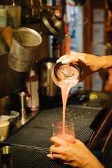 Fototapeta na wymiar Making a red fruit cocktail in a bar 