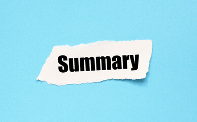 The word SUMMARY on a small piece of paper and a blue background.