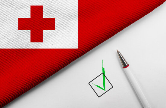  pencil, flag of Tonga and check mark on paper sheet
