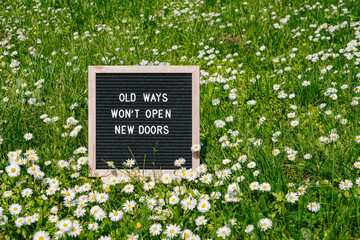 Old Ways Won't Open New Doors. Motivational quote on black letter board on pink background. Concept inspirational quote of the day. Greeting card, postcard