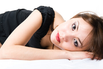 Close-up. Young japanese girl lying on the floor. Beautiful make-up. Isolated