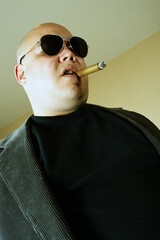 Cross-processed image of a mobster, gangster, or boss. Harsh lighting and cross-processing for...