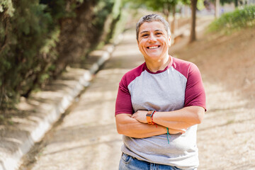 Outdoor portrait of an adult lesbian woman smiling and looking at the camera