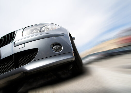 Fast generic car with no logo moving with motion blur