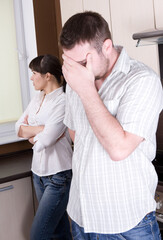 angry couple with problems in kitchen