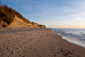 Fototapeta na wymiar fishermen on the beach at sunset baltic sea