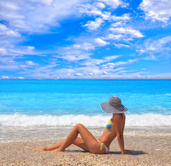 Fototapeta na wymiar Beautiful young woman enjoying the Ionian sea in Greece