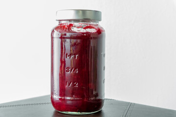 Cranberry Sauce or Jam in Glass Jar on White Background