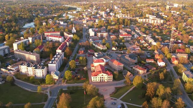 A small border town in Latvia. Valka city at sunset. Drone flight over the city