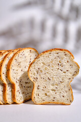 Fresh sliced bread on toast on plates on a light background. Sweet pastries. Food and nutrition concept
