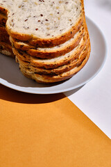 Fresh sliced bread on toast on plates on a light background. Sweet pastries. Food and nutrition concept
