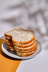 Fresh sliced bread on toast on plates on a light background. Sweet pastries. Food and nutrition concept