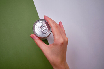 Empty soda can, focus on drink on light background. Place for text and information