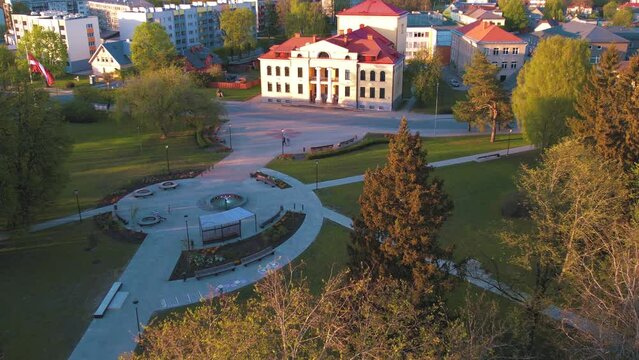 A small border town in Latvia. Valka city at sunset. Drone flight over the city