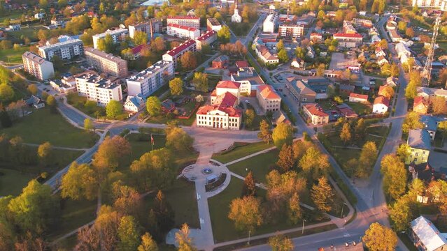 A small border town in Latvia. Valka city at sunset. Drone flight over the city
