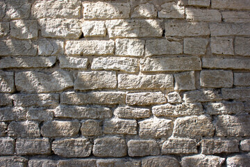 Old brick light wall. Antique brick building. Ancient erection of a wall of light color.