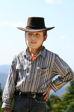 Country boy in highland countryside wearing a hat to shield the sun     200iso