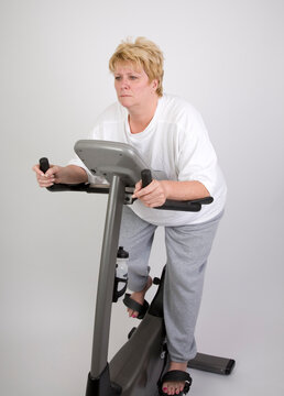 woman looking bored on exercise bike