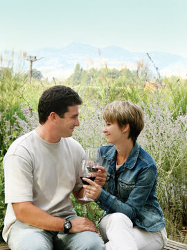 Young couple having picnic with wine