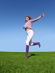 Fototapeta na wymiar Happy woman running on grass