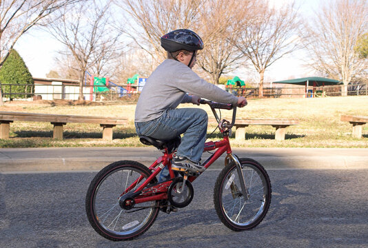 A young boy riding his bike.