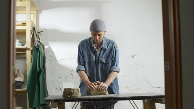 The artist kneads the clay and cuts it in half. Preparation of material for finishing blanks for ceramic products. High quality 4k footage