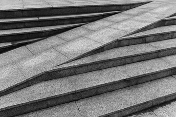 Outdoor urban gray granite stairs with a ramp, abstract architecture