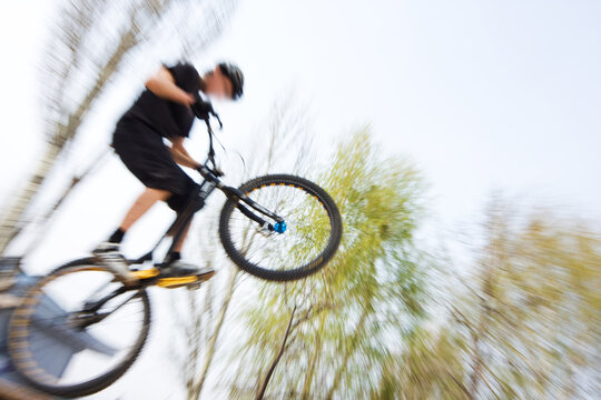 Boy on a bmx/mountain bike jumping. Motion blur photo f/x