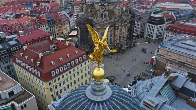 Drone shot of golden statue on the Kunsthalle in Lipsius building, known and crowned as the art academy, on the Br&uuml;hlsche Terrasse,  . Dresden , Germany