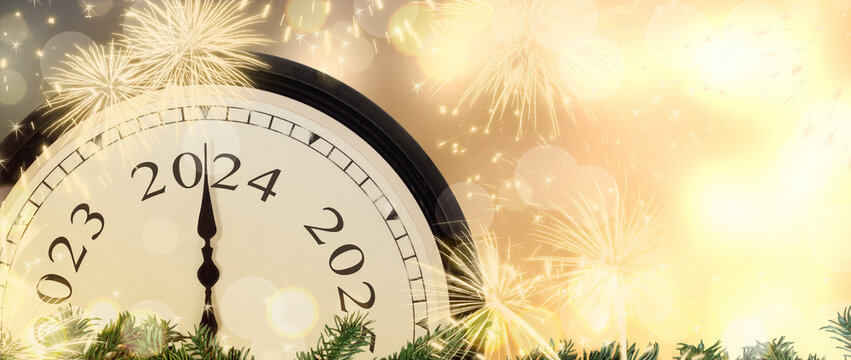 New Year's Eve 2024 concept. Clock hands on year number 2024. Gold magic background with fireworks and blurred lights.