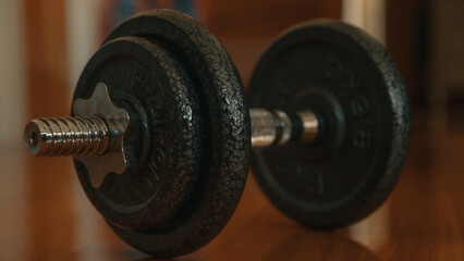 Dumbbells on a wooden floor. Close-up.
