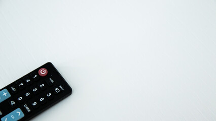 TV remote control on white background. Selective focus and shallow depth of field.