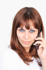 Pretty girl talking on the phone. Isolated on white
