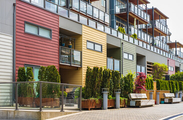 Facade of new residential townhouses. Apartment buildings in Canada. Modern complex of apartment buildings in summer