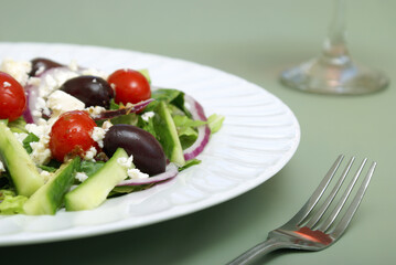 A delicious greek salad on a table.