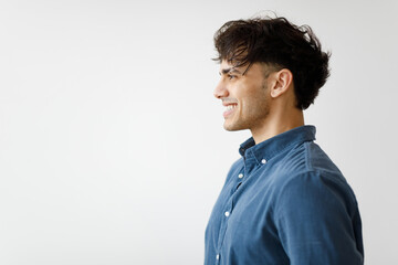 Profile Shot Of Middle Eastern Man Smiling Against White Wall